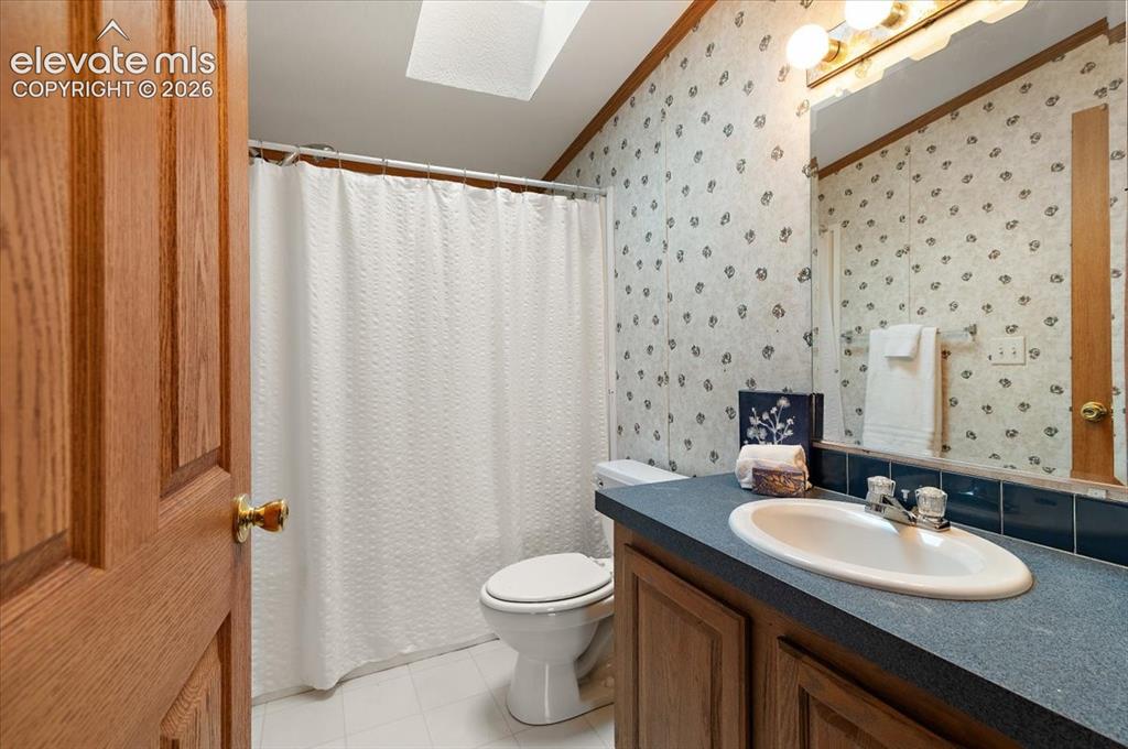 Image 12 of 23: Bathroom featuring a vanity with an integrated sink, built-in cabinetry, wa