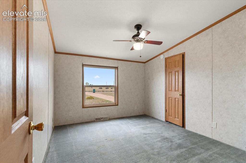 Image 13 of 23: Wall-to-wall carpeting, window with wood-finish trim, wood-finish interior