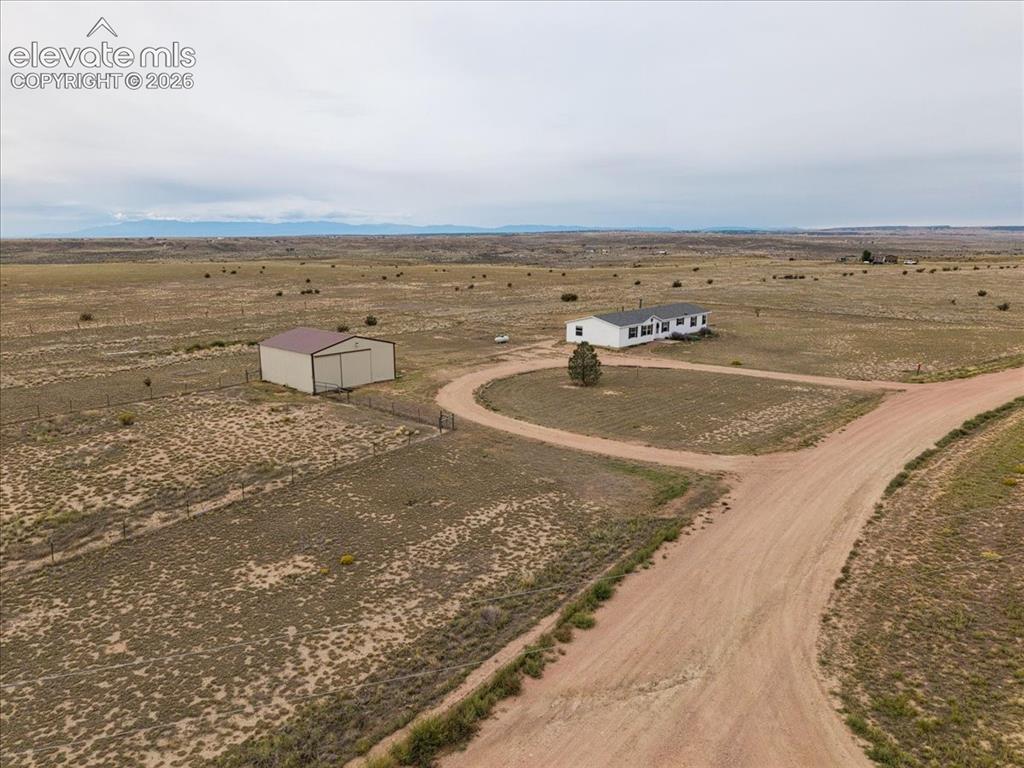 Image 20 of 23: Rural property featuring a single-story residence, a detached metal barn, a