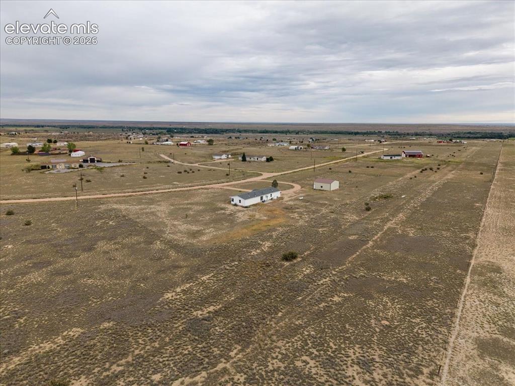 Image 22 of 23: Expansive surrounding land with scattered buildings