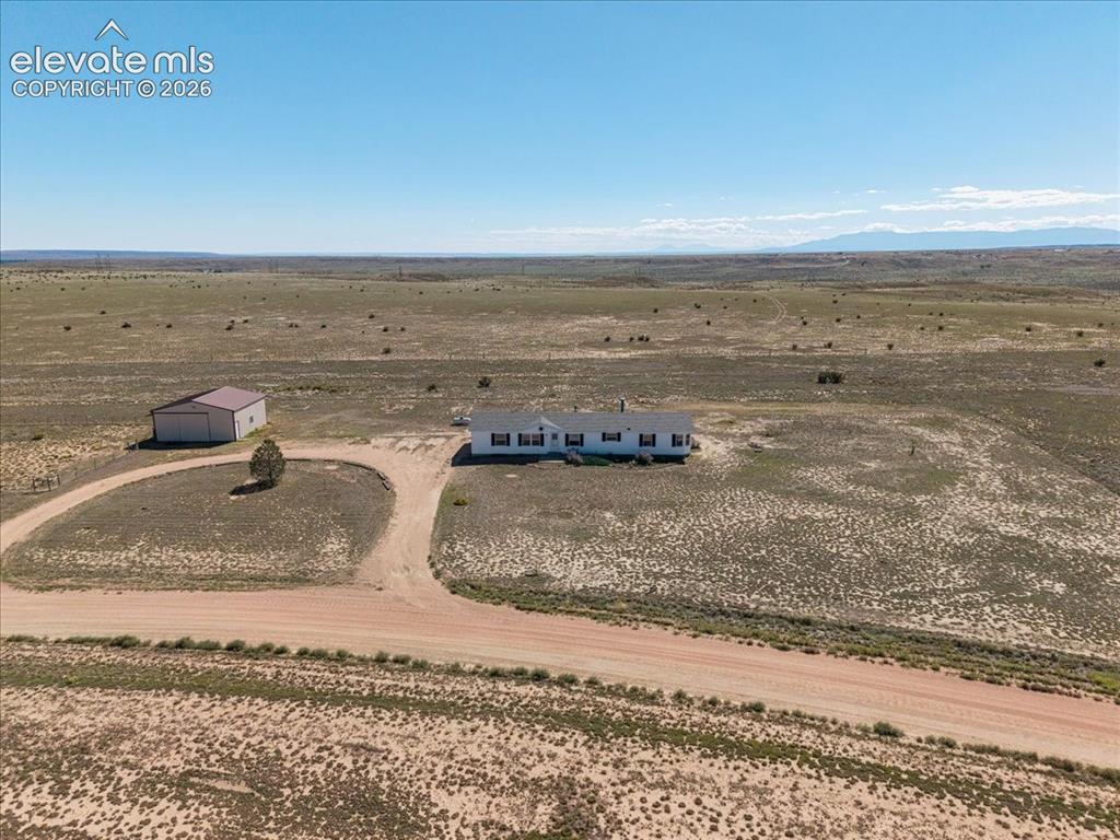 Image 22 of 25: Expansive property featuring a single-story residence with a detached metal