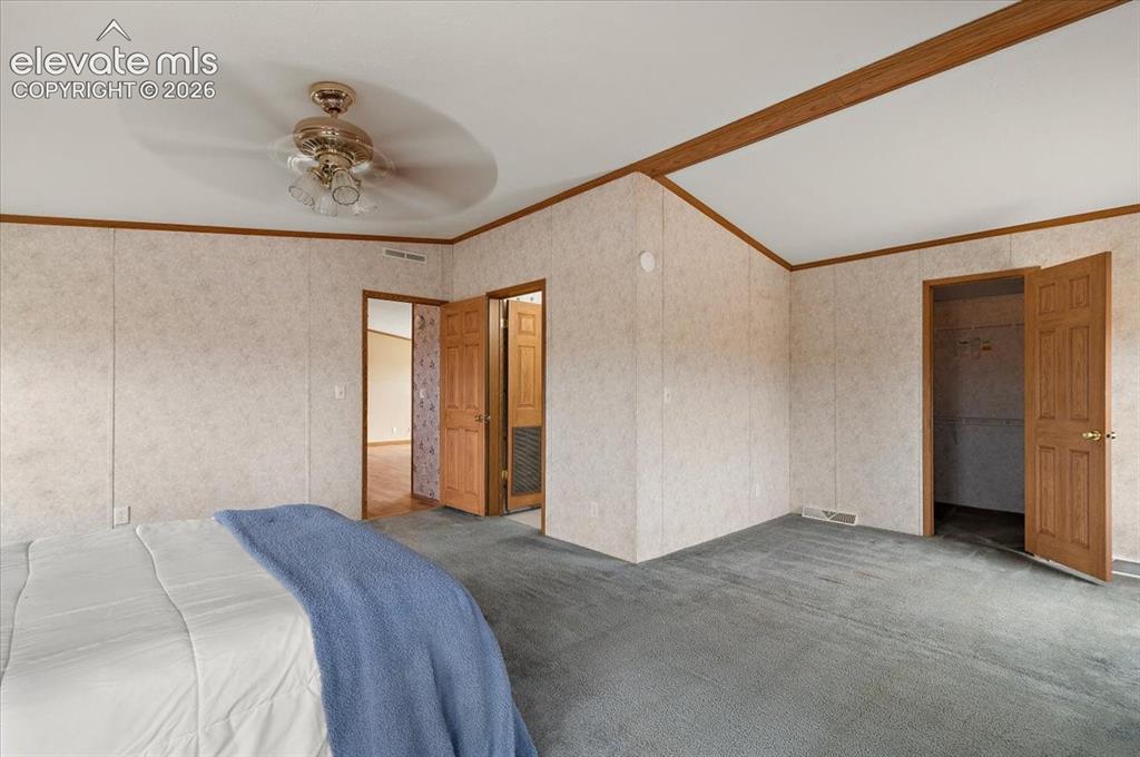 Image 8 of 23: Vaulted ceiling with wood-finish beam, ceiling fan with light fixture, gray