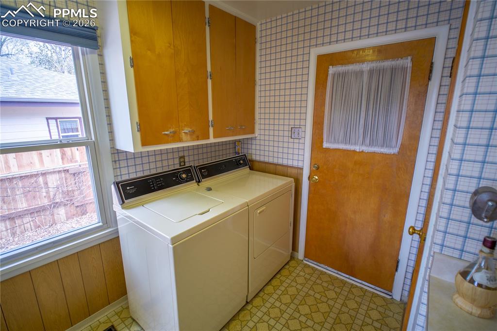 Image 15 of 28: right off the kitchen and adjacent to the garage makes doing laundry super 