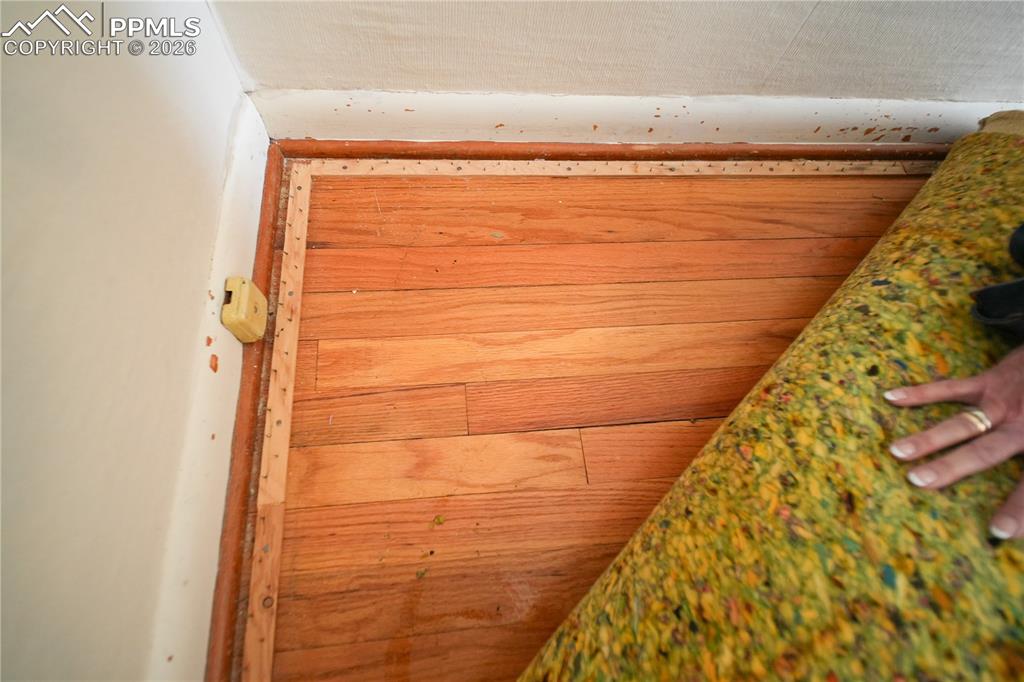 Image 20 of 28: This shows the hardwood flooring underneath the carpet
