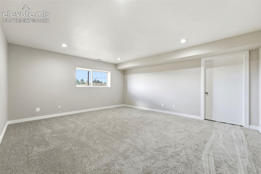 Image 26 of 50: Neutral wall tones and recessed lighting