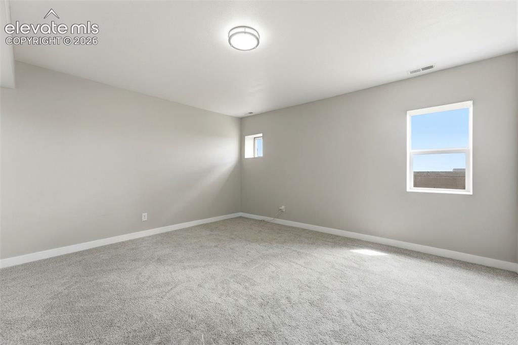 Image 28 of 50: Plush gray carpeting, light neutral wall paint, white trim, recessed ceilin