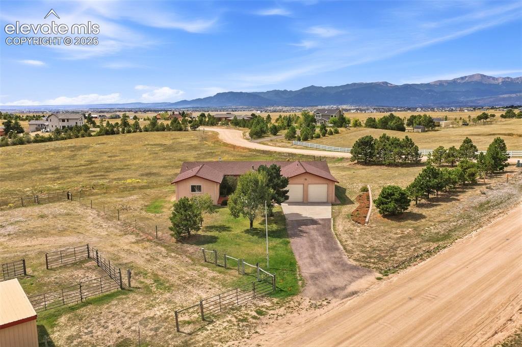 Image 45 of 50: Spacious rural property featuring a single-story residence, attached two-ca