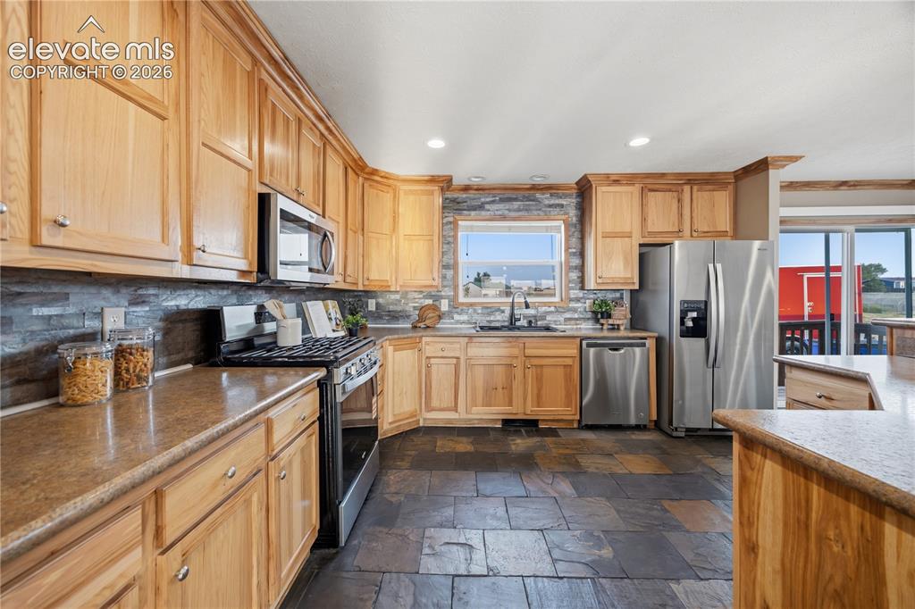 Image 11 of 49: The Kitchen has all stainless Steel appliances and ample cabinet space.