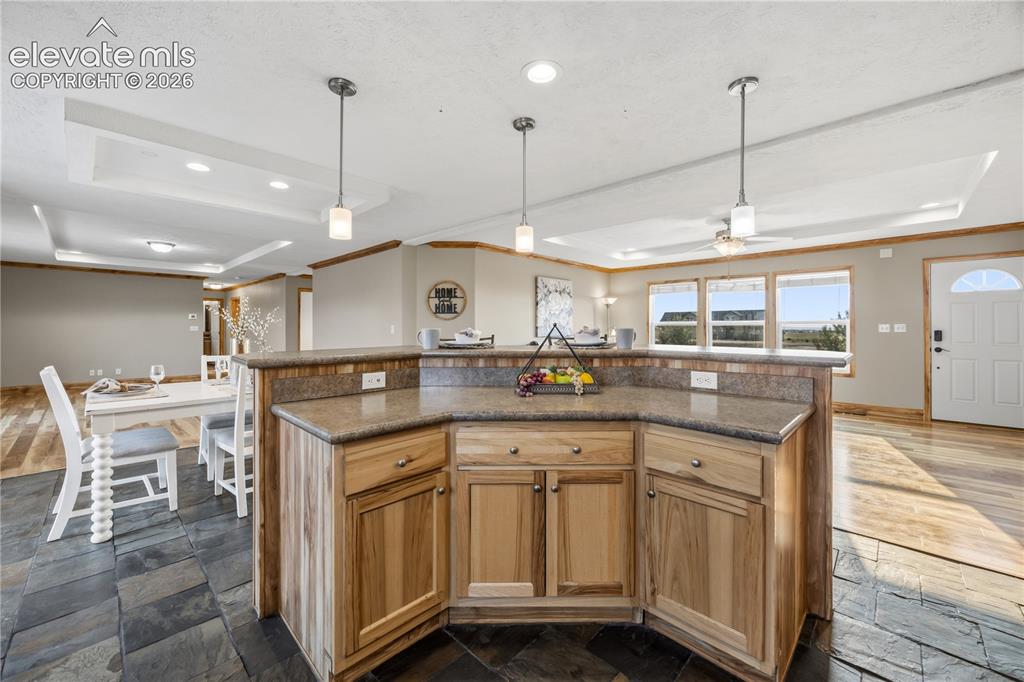 Image 12 of 49: Kitchen Island has additional work space, more cabinets, and a breakfast ba