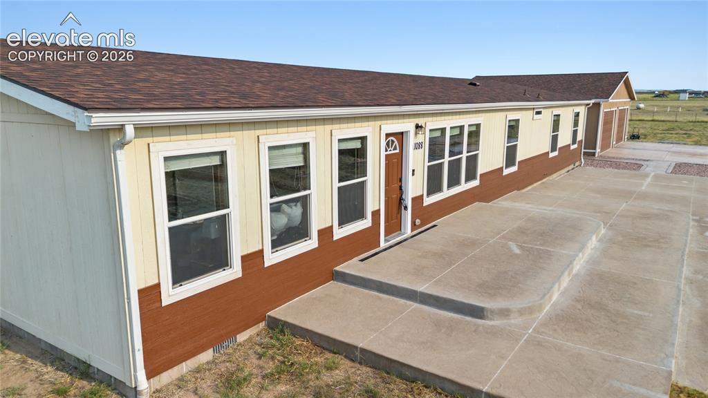 Image 2 of 49: Home has a large, stepped, concrete patio