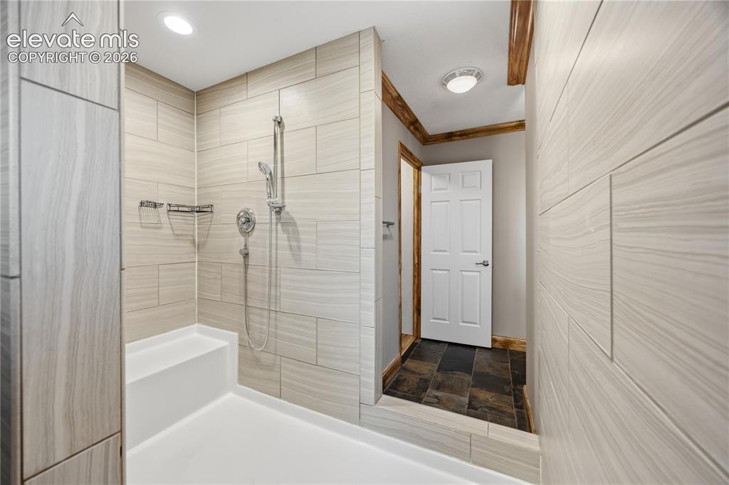 Image 23 of 49: behind the vanity is the large shower with entry from both sides.
