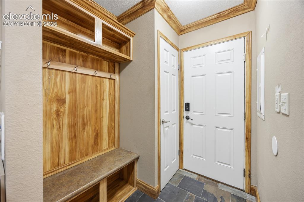 Image 39 of 49: Just past the laundry area is a mudroom at the side entry door.