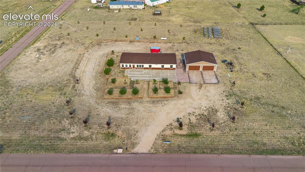 Image 43 of 49: Home has a large Raised bed garden in the back.