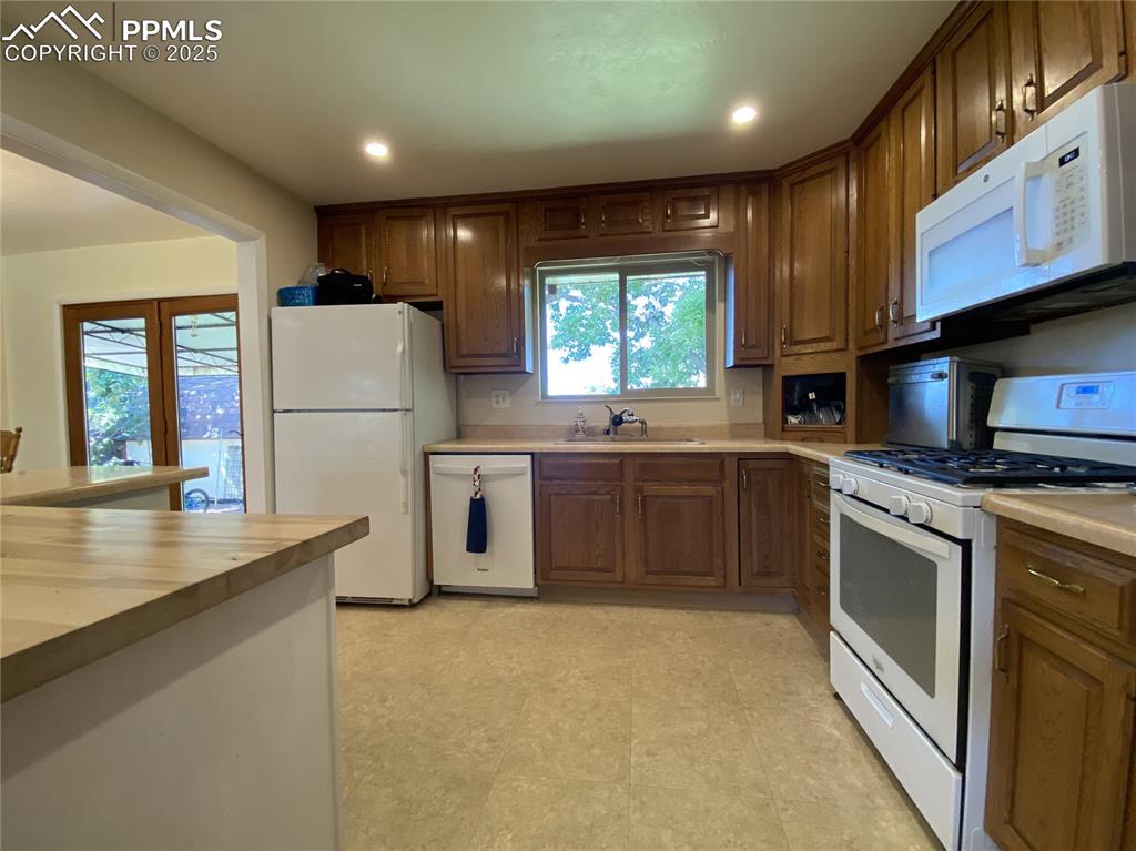 Image 13 of 35: All white appliances highlight the clean, functional kitchen