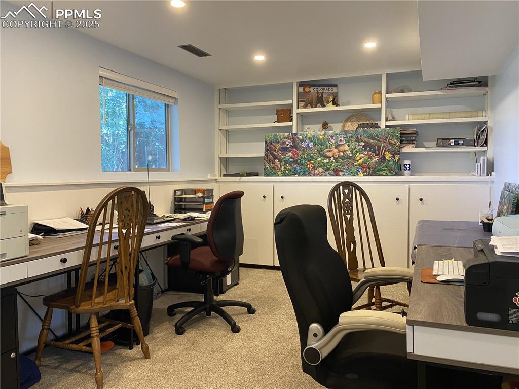 Image 24 of 35: The office also features custom cabinets and bookshelves