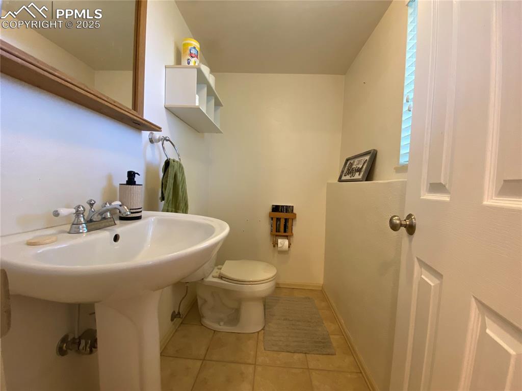 Image 26 of 35: The powder room is convenient from the backyard as well