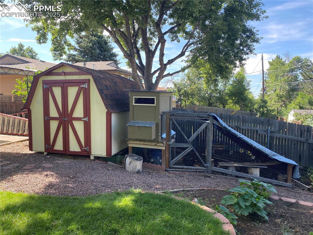 Image 29 of 35: The storage shed and chicken coop stay with the home