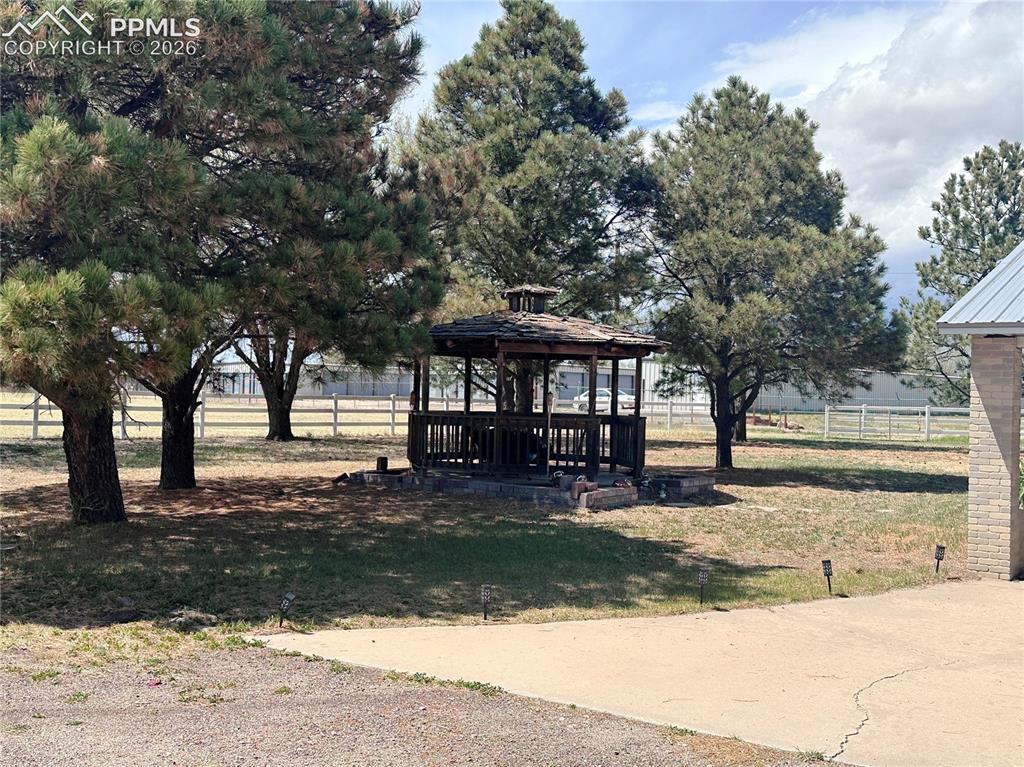 Image 12 of 48: Gazebo shown nestled in the trees .