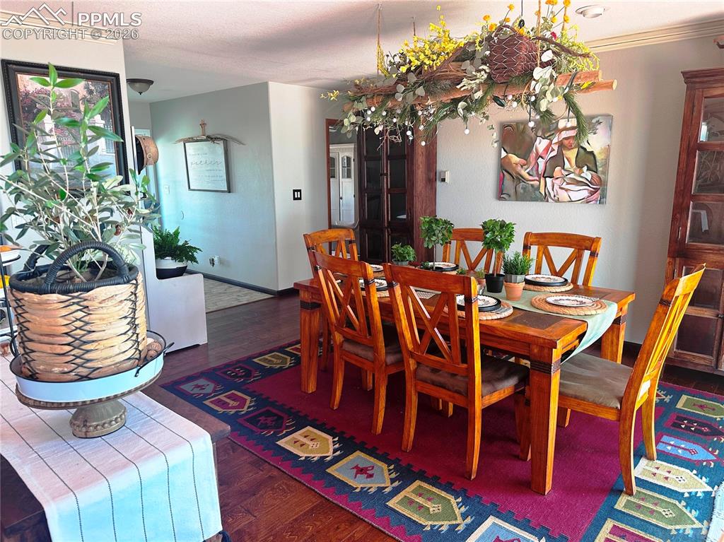 Image 14 of 48: Dining room with entry from outside and hallway to primary bedroom, guest b