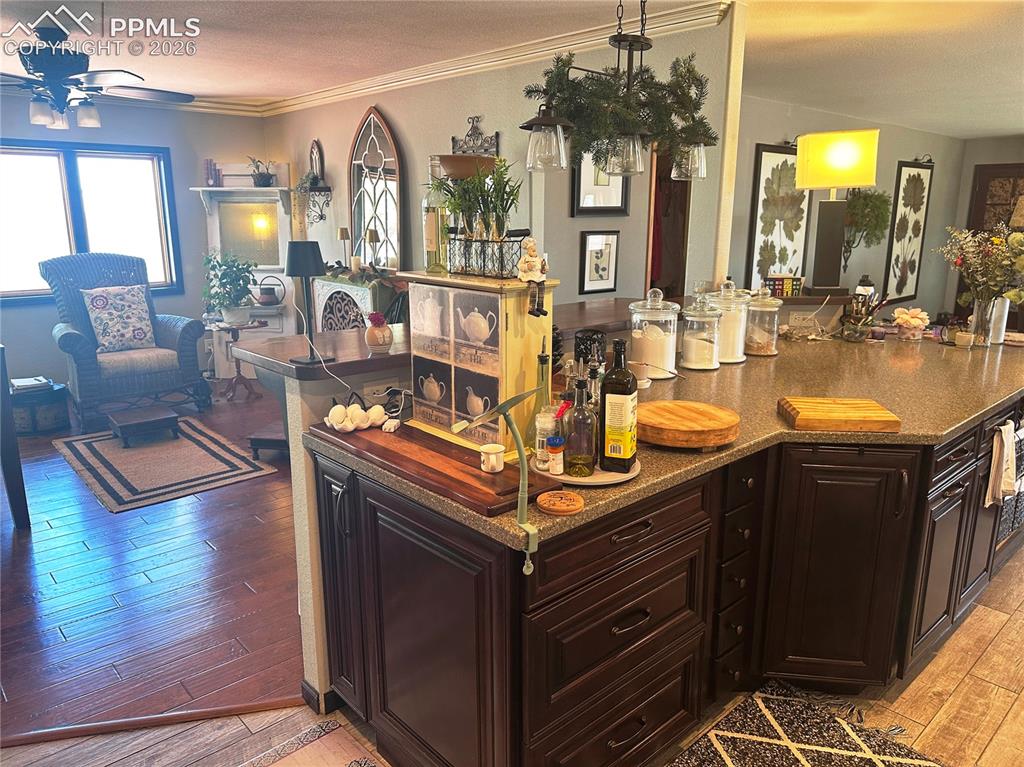 Image 21 of 48: view of sitting area from kitchen. Note different flooring intentionally la