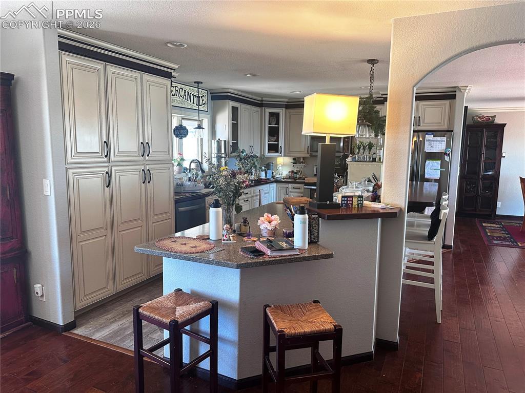 Image 24 of 48: Additional mini-dinette area shown, with longer breakfast bar at the right.