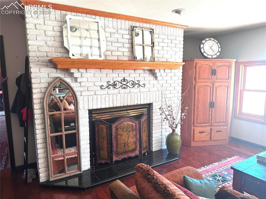 Image 25 of 48: Living room has propane gas fireplace as does primary bedroom fireplace. In