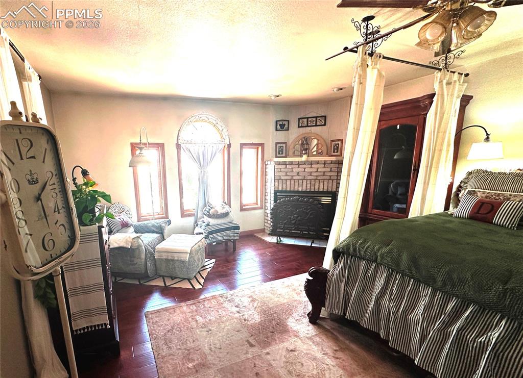 Image 29 of 48: Primary bedroom with propane fireplace at the top and sitting area to the l