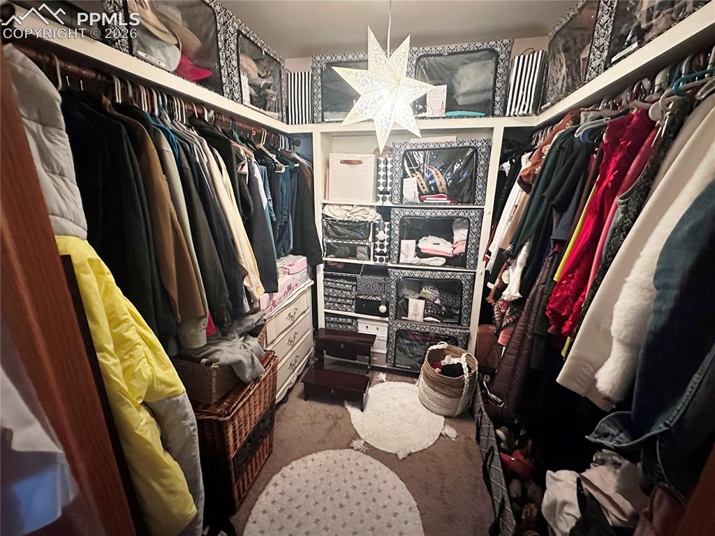 Image 30 of 48: Large walk in closet. There is also a linen closet outside the bedroom ent