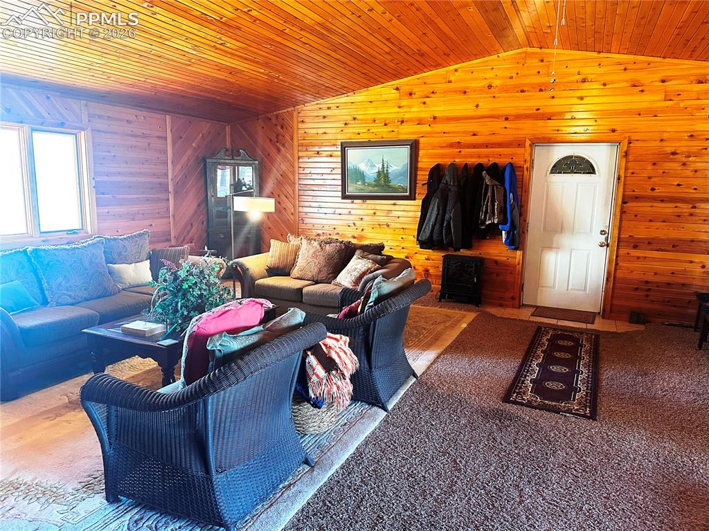 Image 43 of 48: Portion used for office/sitting area is carpeted. The rest has tile. Door