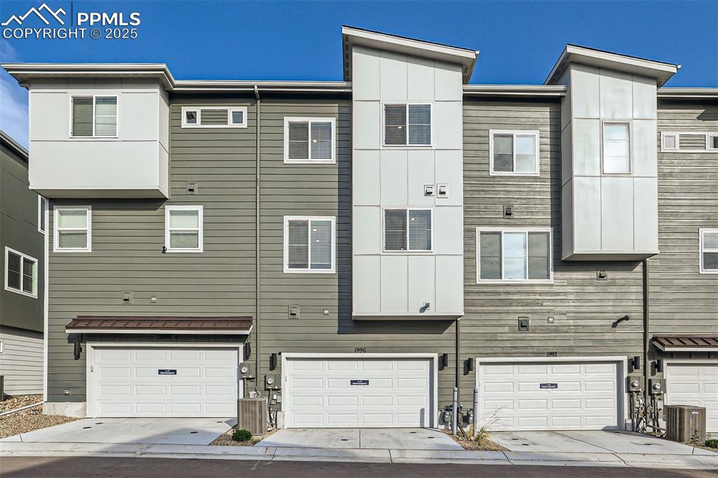 Image 16 of 16: Back of property with a garage and driveway