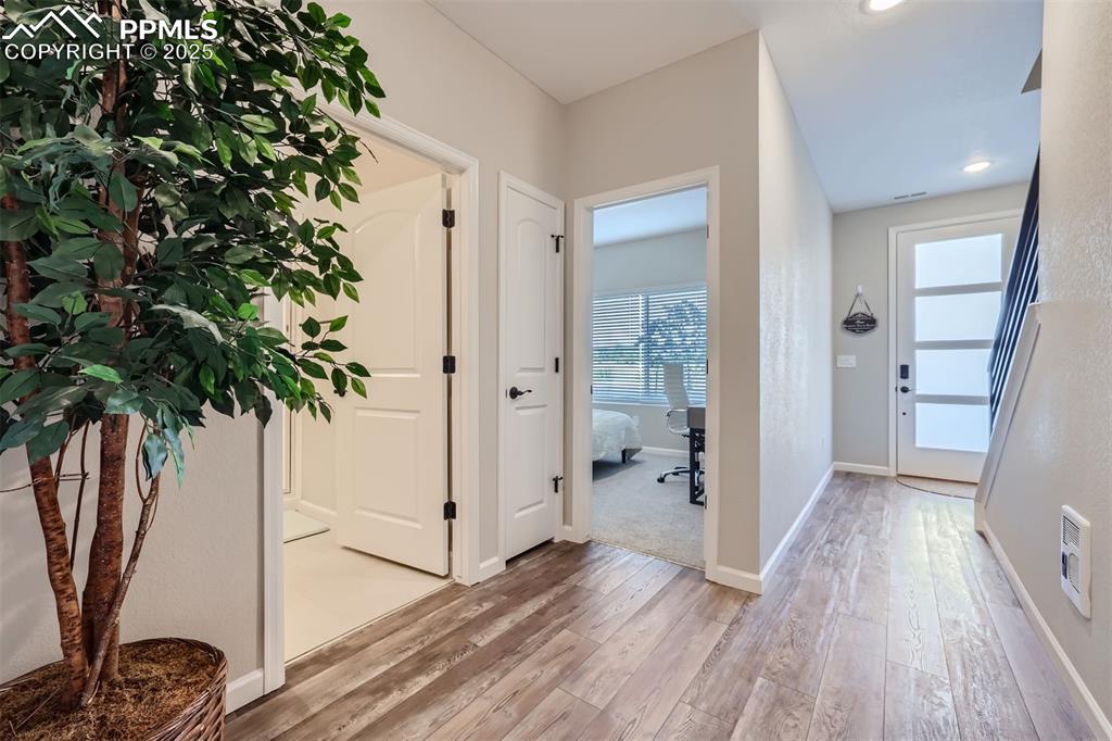 Image 3 of 16: Foyer entrance with light wood-style floors and baseboards