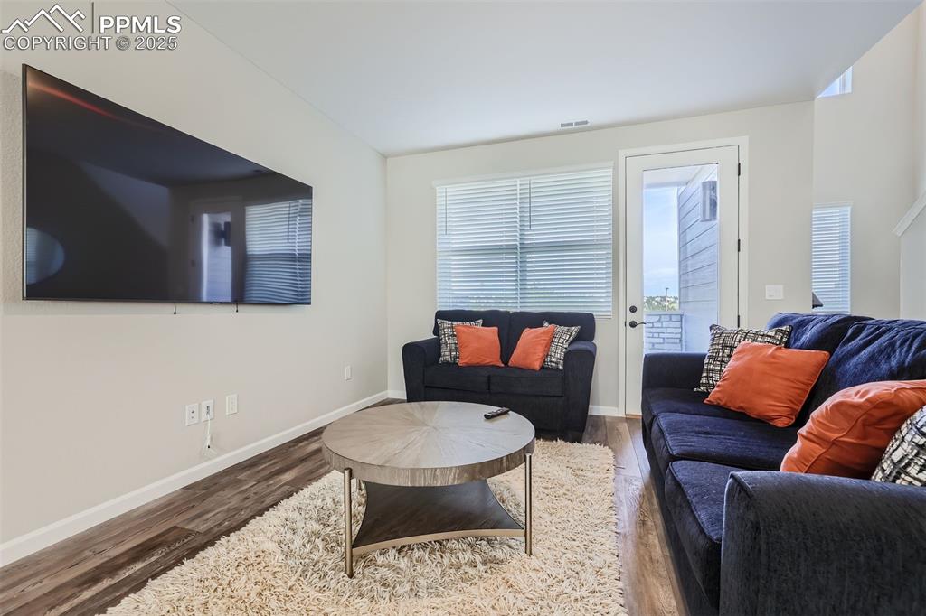 Image 6 of 16: Living area with wood finished floors