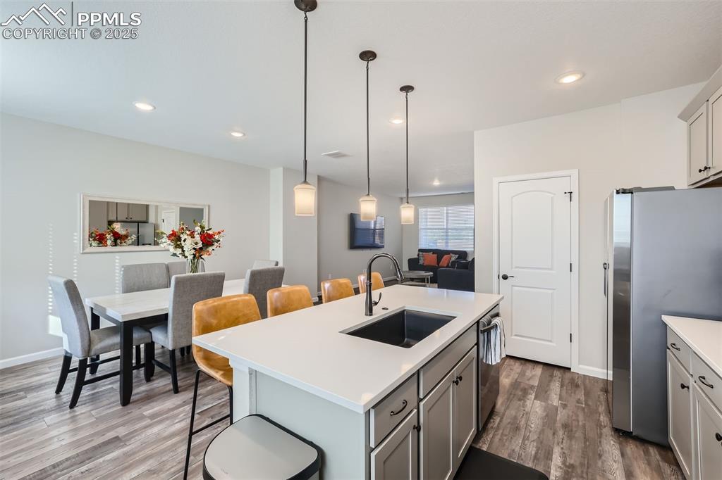 Image 9 of 16: Kitchen with a breakfast bar, appliances with stainless steel finishes, an