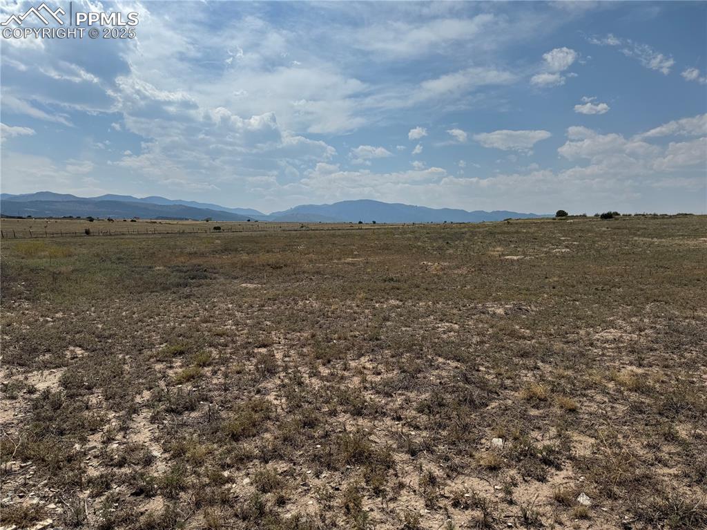 Image 15 of 17: View of mountain backdrop with rural landscape