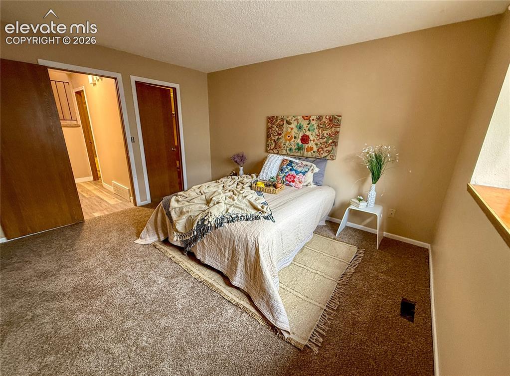 Image 10 of 26: Room featuring wall-to-wall carpeting, neutral paint finish, and solid core