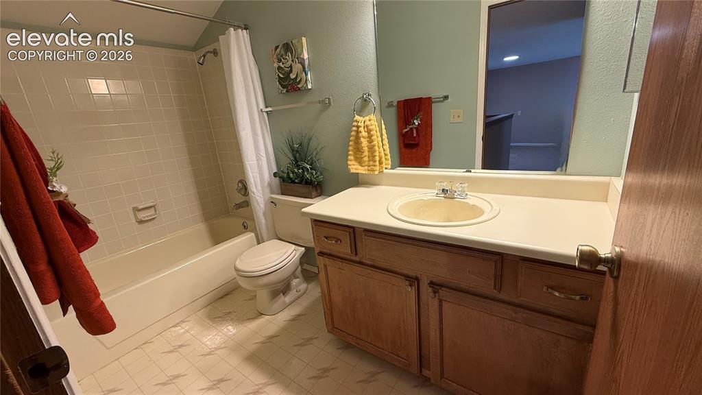 Image 15 of 26: Bathroom featuring a wood vanity with a lite colored countertop, an integra