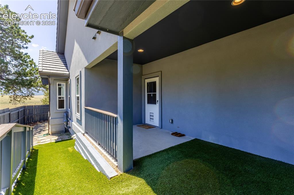 Image 47 of 50: Side yard with door to laundry/mud room and dog wash. 