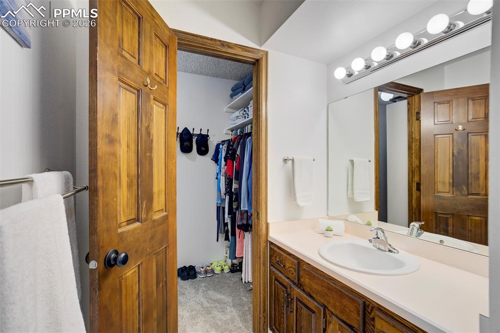 Image 16 of 50: Dual Vanities and Closets