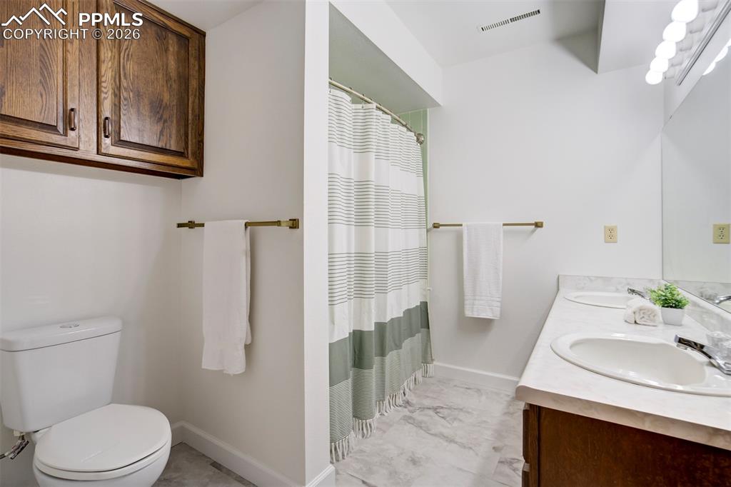 Image 29 of 50: Lower Level Newly Updated Bathroom with Dual Vanity