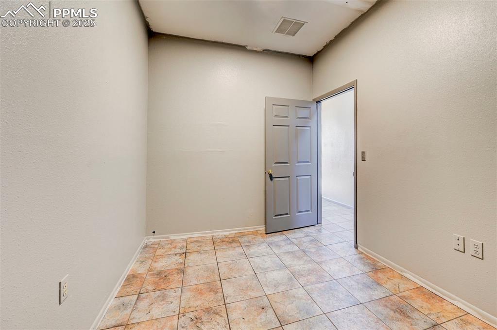 Image 31 of 42: Unfurnished room with baseboards and light tile patterned floors