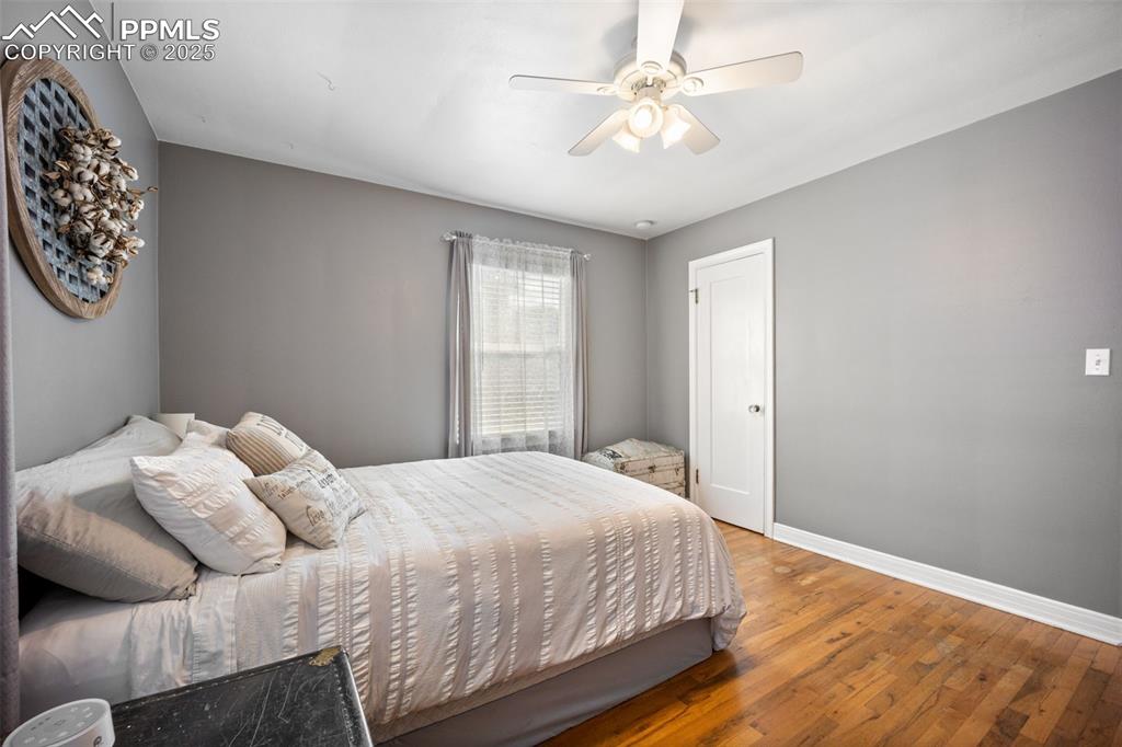 Image 14 of 47: Bedroom featuring wood finished floors and a ceiling fan