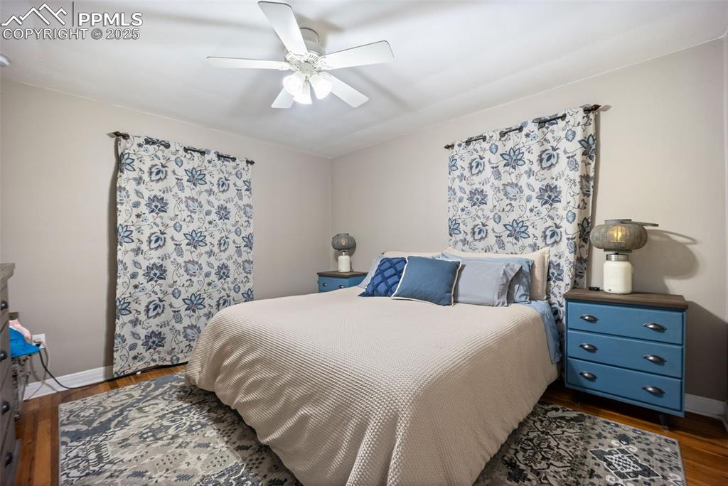 Image 17 of 47: Bedroom featuring dark wood-type flooring and a ceiling fan