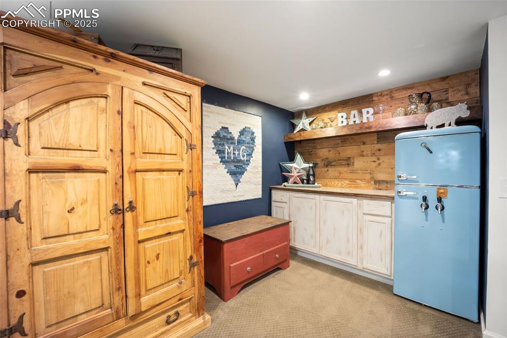 Image 20 of 47: Kitchen with freestanding refrigerator, light carpet, recessed lighting, an