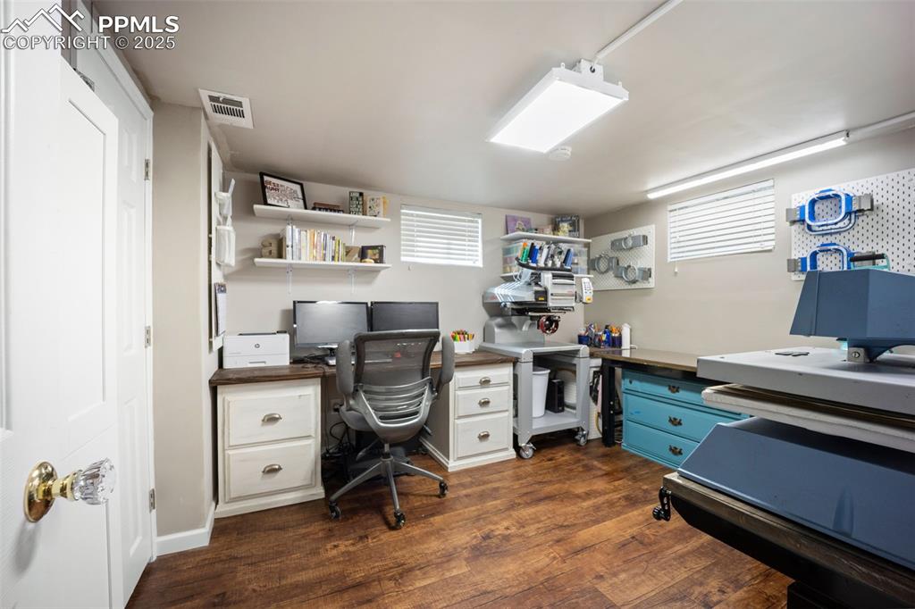 Image 21 of 47: Office space featuring dark wood-type flooring