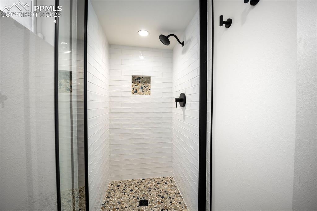 Image 24 of 47: Bathroom featuring a stall shower