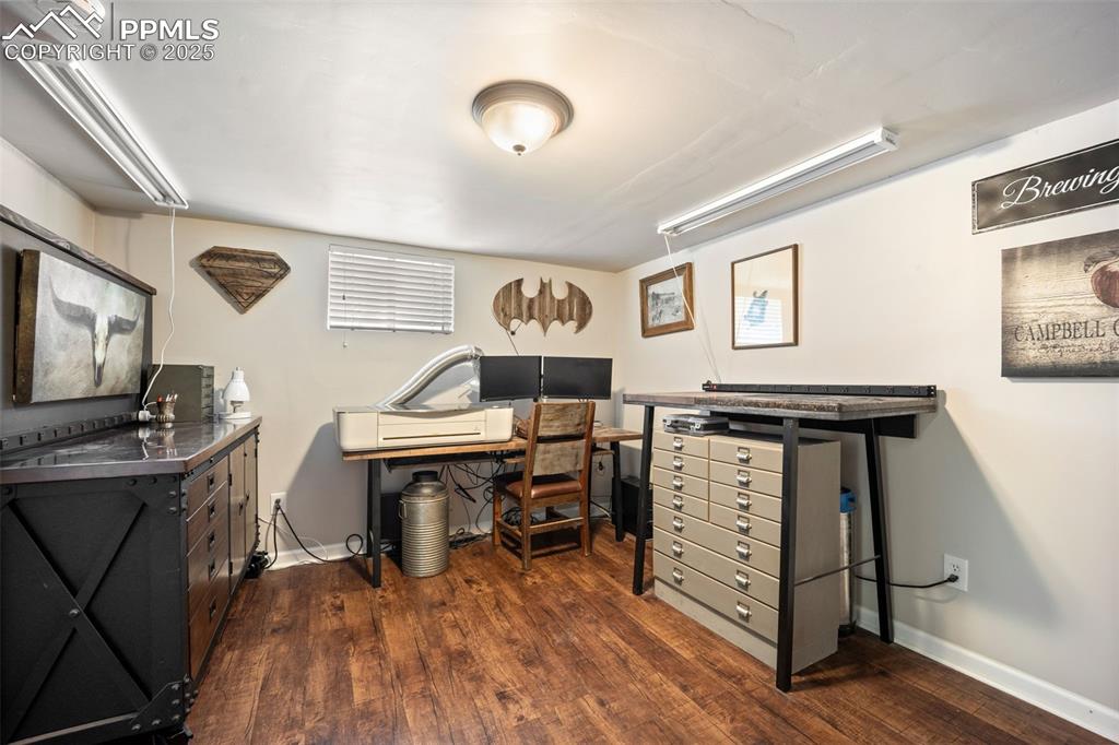 Image 26 of 47: Office featuring dark wood finished floors and baseboards