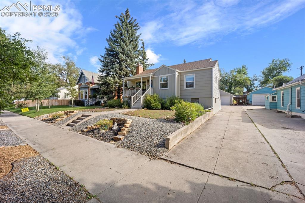 Image 3 of 47: View of front of property featuring covered porch, a detached garage, and a