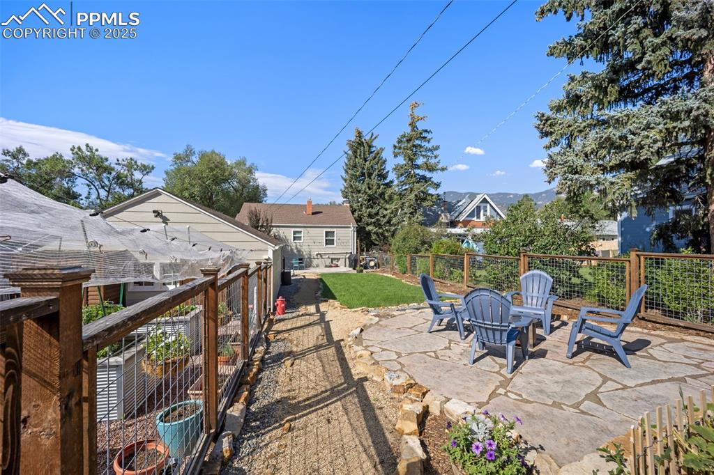Image 34 of 47: View of patio with a fire pit