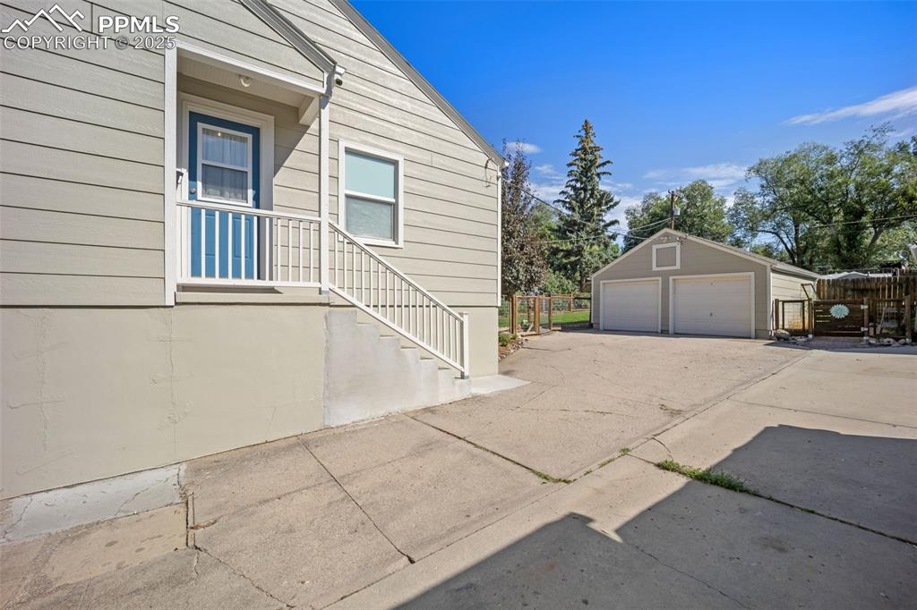 Image 42 of 47: View of side of home featuring a garage and an outdoor structure