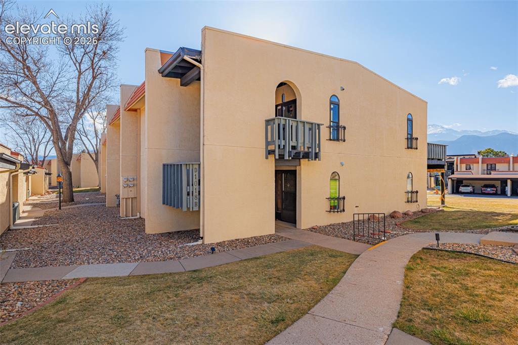 Caption: Stucco exterior with arched windows, wrought iron window boxes, and a second-story balcony